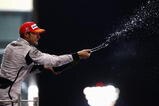 ABU DHABI, UNITED ARAB EMIRATES - NOVEMBER 01:  Jenson Button of Great Britain and Brawn GP celebrates on the podium after finishing third during the Abu Dhabi Formula One Grand Prix at the Yas Marina Circuit on November 1, 2009 in Abu Dhabi, United Arab Emirates.  (Photo by Paul Gilham/Getty Images)