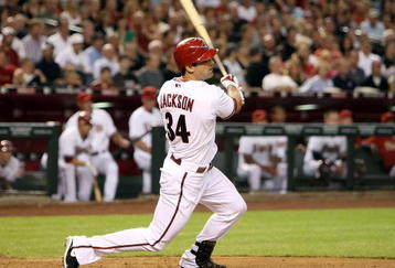 PHOENIX - APRIL 10:  Conor Jackson #34 of the Arizona Diamondbacks hits a two-run single against the Los Angeles Dodgers during the third inning of the game at Chase Field on April 10, 2009 in Phoenix, Arizona.  (Photo by Christian Petersen/Getty Images)