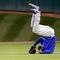 HOUSTON - APRIL 06:  Milton Bradley #21 of the Chicago Cubs flips over after missing a fly ball against the Houston Astros on Opening Day on April 6, 2009 at Minute Maid Park in Houston, Texas.  The Cubs defeated the Astros 4-2.  (Photo by Chris Graythen/Getty Images)
