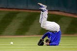 HOUSTON - APRIL 06:  Milton Bradley #21 of the Chicago Cubs flips over after missing a fly ball against the Houston Astros on Opening Day on April 6, 2009 at Minute Maid Park in Houston, Texas.  The Cubs defeated the Astros 4-2.  (Photo by Chris Graythen/Getty Images)