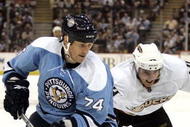 PITTSBURGH, PA - NOVEMBER 16:  Jay McKee #74 of the Pittsburgh Penguins and Joffrey Lupul #14 of the Anaheim Ducks battle for a loose puck in the second period at Mellon Arena on November 16, 2009 in Pittsburgh, Pennsylvania.  (Photo by Justin K. Aller/Getty Images)