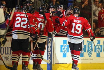 CHICAGO - NOVEMBER 09: Members of the Chicago Blackhawks congratulate Jonathan Toews #19 and his line after Toews scored a third period goal against the Los Angeles Kings at the United Center on November 9, 2009 in Chicago, Illinois. The Blackhawks defeated the Kings 4-1. (Photo by Jonathan Daniel/Getty Images)