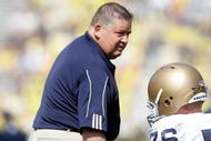 ANN ARBOR, MI - SEPTEMBER 12:  Notre Dame head coach Charlie Weis shakes the hand of Andrew Nuss #76 before the game against Michigan at Michigan Stadium on September 12, 2009 in Ann Arbor, Michigan.  (Photo by Domenic Centofanti/Getty Images)