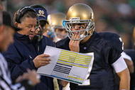 SOUTH BEND, IN - OCTOBER 17: Head coach Charlie Weis of the Notre Dame Fighting Irish gives a play to quarterback Jimmy Clausen #7 during a game against the USC Trojans at Notre Dame Stadium on October 17, 2009 in South Bend, Indiana. USC defeated Notre Dame 34-27. (Photo by Jonathan Daniel/Getty Images)