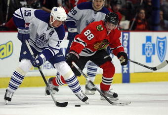 CHICAGO - NOVEMBER 13: Tomas Kaberle #15 of the Toronto Maple Leafs controls the puck under pressure from Patrick Kane #88 of the Chicago Blackhawks at the United Center on November 13, 2009 in Chicago, Illinois. (Photo by Jonathan Daniel/Getty Images)