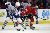 CHICAGO - NOVEMBER 13: Tomas Kaberle #15 of the Toronto Maple Leafs controls the puck under pressure from Patrick Kane #88 of the Chicago Blackhawks at the United Center on November 13, 2009 in Chicago, Illinois. (Photo by Jonathan Daniel/Getty Images)