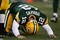 GREEN BAY, WI - NOVEMBER 15: Aaron Rodgers #12 of the Green Bay Packers is slow to get up after being hit during a game against the Dallas Cowboys at Lambeau Field on November 15, 2009 in Green Bay, Wisconsin. The Packers defeated the Cowboys 17-7.  (Photo by Jonathan Daniel/Getty Images)