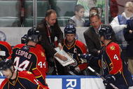 SUNRISE, FL - NOVEMBER 16: Head coach Peter DeBoer of the Florida Panthers goes over a play with Dennis Seidenberg #4 and Jordan Leopold #44 during th eovertime period against the Los Angeles Kings on November 16, 2009 at the BankAtlantic Center in Sunrise, Florida. The Kings defeated the Panthers 4-3. (Photo by Joel Auerbach/Getty Images)