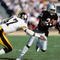 LOS ANGELES, CA - JANUARY 1:  Cliff Branch #21 of the Los Angeles Raiders runs the ball against Mel Blount #47 of the Pittsburgh Steelers during the AFC Divisional playoff game at the Los Angeles Memorial Coliseum on January 1, 1984 in Los Angeles, California.  The Raiders won 38-10. (Photo by George Rose/Getty Images)