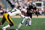 LOS ANGELES, CA - JANUARY 1:  Cliff Branch #21 of the Los Angeles Raiders runs the ball against Mel Blount #47 of the Pittsburgh Steelers during the AFC Divisional playoff game at the Los Angeles Memorial Coliseum on January 1, 1984 in Los Angeles, California.  The Raiders won 38-10. (Photo by George Rose/Getty Images)