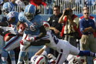 NASHVILLE, TN - NOVEMBER 15:  Chris Johnson #28 of the Tennessee Titans fights to break free from Marshawn Lynch #23 of the Buffalo Bills in their NFL game at LP Field on November 15, 2009 in Nashville, Tennessee.  (Photo by John Sommers II/Getty Images)