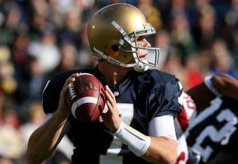 SOUTH BEND, IN - OCTOBER 17: Jimmy Clausen #7 of the Notre Dame Fighting Irish looks for a receiver against the USC Trojans at Notre Dame Stadium on October 17, 2009 in South Bend, Indiana. USC defeated Notre Dame 34-27. (Photo by Jonathan Daniel/Getty Images)