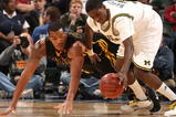 INDIANAPOLIS - MARCH 12:  Manny Harris #3 of the Michigan Wolveriens attempts to control a loose ball against Jarryd Cole #50 of the Iowa Hawkeyes during the first round of the Big Ten Men's Basketball Tournament at Conseco Fieldhouse on March 12, 2009 in Indianapolis, Indiana.  (Photo by Jonathan Daniel/Getty Images)
