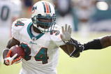MIAMI - JANUARY 4:  Ricky Williams #34 of the Miami Dolphins carries the ball during an AFC Wild Card playoff game against the Baltimore Ravens on January 4, 2009 at Dolphin Stadium in Miami, Florida. (Photo by Gregory Shamus/Getty Images)