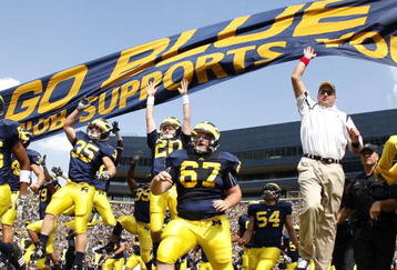 ANN ARBOR, MI - SEPTEMBER 05:  Head coach Rich Rodriguez enters the stadium with his team prior to playing the Western Michigan Broncos on September 5, 2009 at Michigan Stadium in Ann Arbor, Michigan.  (Photo by Gregory Shamus/Getty Images)