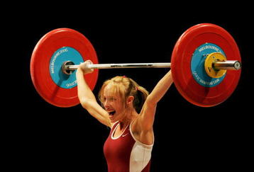 MELBOURNE, AUSTRALIA - MARCH 16:  Marilou Dozois-Prevost of Canada celebrates as she makes a lift in the Snatch category during the weightlifting Women's 48kg Final at the Melbourne Exhibition Centre during day one of the Melbourne 2006 Commonwealth Games March 16, 2006 in Melbourne, Australia.  (Photo by Cameron Spencer/Getty Images)