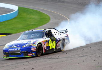 AVONDALE, AZ - NOVEMBER 15:  Jimmie Johnson driver of the #48 Lowe's Chevrolet celebrates by doing a burnout in turn one after winning the NASCAR Sprint Cup Series Checker O'Reilly Auto Parts 500 at Phoenix International Raceway on November 15, 2009 in Avondale, Arizona.  (Photo by Robert Laberge/Getty Images for NASCAR)