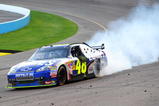 AVONDALE, AZ - NOVEMBER 15:  Jimmie Johnson driver of the #48 Lowe's Chevrolet celebrates by doing a burnout in turn one after winning the NASCAR Sprint Cup Series Checker O'Reilly Auto Parts 500 at Phoenix International Raceway on November 15, 2009 in Avondale, Arizona.  (Photo by Robert Laberge/Getty Images for NASCAR)