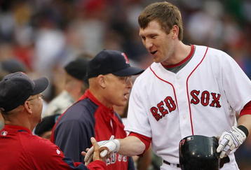 BOSTON - JULY 07:  Jason Bay #44 of the Boston Red Sox is congratulated by manager Terry Francona #47 after Bay hit a solo home run in the second inning against the Oakland Athletics on July 7, 2009 at Fenway Park in Boston, Massachusetts.  (Photo by Elsa/Getty Images)