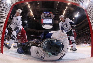 GLENDALE, AZ - NOVEMBER 16:  Goaltender Mike Smith #41 of the Tampa Bay Lightning covers the puck as David Hale #21 and Matt Walker #8 skate in during the NHL game against the Phoenix Coyotes at Jobing.com Arena on November 16, 2009 in Glendale, Arizona. The Lightning defeated the Coyotes 4-1.  (Photo by Christian Petersen/Getty Images)