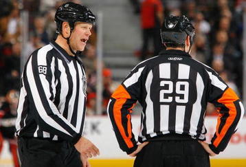 OTTAWA, ON - NOVEMBER 10:  Referees Scott Driscolll and Ian Walsh talk on the ice during the game between the Edmonton Oilers and the Ottawa Senators in a game at Scotiabank Place on November 10, 2009 in Ottawa, Canada.  (Photo by Phillip MacCallum/Getty Images)