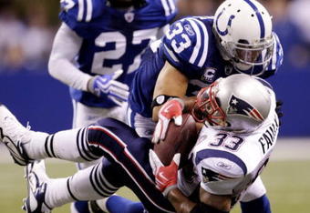 INDIANAPOLIS - NOVEMBER 15:  Melvin Bullitt #33 of the Indianapolis Colts tackles Kevin Faulk #33 of the New England Patriots short of a first down to gain possesion late in the fourth quarter of the game at Lucas Oil Stadium on November 15, 2009 in Indianapolis, Indiana. The Colts won the 35-34. (Photo by Jamie Squire/Getty Images)