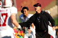 LOS ANGELES, CA - NOVEMBER 14:  Head coach Jim Harbaugh of the Stanford Cardinal greets his offense after a touchdown during the game with the USC Trojans on November 14, 2009 at the Los Angeles Coliseum in Los Angeles, California.  Stanford won 55-21.  (Photo by Stephen Dunn/Getty Images)