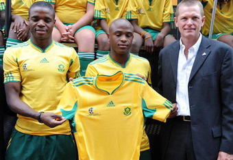 JOHANNESBURG, SOUTH AFRICA - NOVEMBER 11:  Bafana Captain Aaron Mokeona, Tshepo Masilela and Adidas SA MD Brian Kerby present the new Bafana Bafana FIFA World Cup 2010 jersey at the Market Theatre on November 11, 2009 in Johannesburg, South Africa.  (Photo by Lefty Shivambu/Gallo Images/Getty Images)