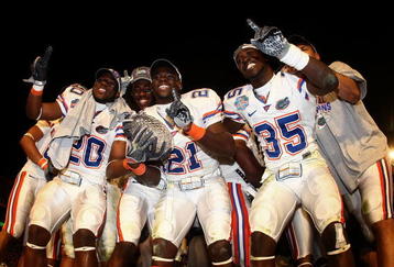 MIAMI - JANUARY 08:  Dorian Munroe #20, Major Wright #21 and Ahmad Black #35 of the Florida Gators celebrate with the trophy after defeating the Oklahoma Sooners in the FedEx BCS National Championship Game at Dolphin Stadium on January 8, 2009 in Miami, Florida. The Gators won the game by a score of 24-14.  (Photo by Donald Miralle/Getty Images)