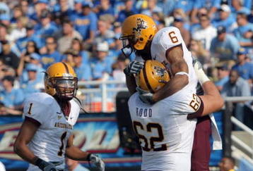 PASADENA, CA - NOVEMBER 10:  Kyle Williams #6 of the Arizona State Sun Devils celebrates his touchdown with Brandon Rodd #62 and Michael Jones #1 to trail the UCLA Bruins 7-10 during the second quarter at the Rose Bowl on November 10, 2007 in Pasadena, California.  (Photo by Harry How/Getty Images)