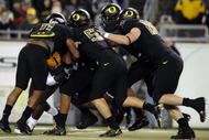 EUGENE,OR - NOVEMBER 14: Linebacker Eddie Pleasant #11, linebacker Casey Matthews #55 and defensive tackle Brandon Bair #88 of the Oregon Ducks gang up to tackle running back Dimitri Nance #31of the Arizona State Sun Devils in the first quarter of the game at Autzen Stadium on November 14, 2009 in Eugene, Oregon. (Photo by Steve Dykes/Getty Images)