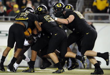 EUGENE,OR - NOVEMBER 14: Linebacker Eddie Pleasant #11, linebacker Casey Matthews #55 and defensive tackle Brandon Bair #88 of the Oregon Ducks gang up to tackle running back Dimitri Nance #31of the Arizona State Sun Devils in the first quarter of the game at Autzen Stadium on November 14, 2009 in Eugene, Oregon. (Photo by Steve Dykes/Getty Images)