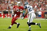 GLENDALE, AZ - NOVEMBER 15:  Quarterback Kurt Warner #13 of the Arizona Cardinals drops back to pass while being defended by Deon Grant #24 of the Seattle Seahawks in the second half at University of Phoenix Stadium on November 15, 2009 in Glendale, Arizona. The Cardinals defeated the Seahawks 31-20.  (Photo by Jeff Gross/Getty Images)