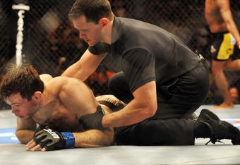 PHILADELPHIA - AUGUST 08:  (Bottom) Forrest Griffin on the ground after being defeated by Anderson Silva during their light heavyweight bout at UFC 101: Declaration at the Wachovia Center on August 8, 2009 in Philadelphia, Pennsylvania.  (Photo by Jon Kopaloff/Getty Images)