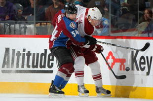 DENVER - NOVEMBER 04:  Peter Mueller #88 of the Phoenix Coyotes tries to control the puck as he fends off David Jones #54 of the Colorado Avalanche at the Pepsi Center on November 4, 2009 in Denver, Colorado. The Avalanche defeated the Coyotes 4-1.  (Photo by Doug Pensinger/Getty Images)
