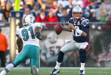 FOXBORO, MA - NOVEMBER 8:  Tom Brady #12 of the New England Patriots looks for an open man against the Miami Dolphins at Gillette Stadium on November 8, 2009 in Foxboro, Massachusetts. (Photo by Jim Rogash/Getty Images)