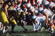 25 Nov 1995: Ohio State and Michigan go head to head in Michigan's 31-23 victory over Ohio State at Michigan Stadium in Ann Arbor, Michigan.