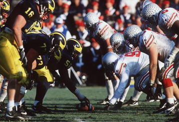 25 Nov 1995: Ohio State and Michigan go head to head in Michigan's 31-23 victory over Ohio State at Michigan Stadium in Ann Arbor, Michigan.