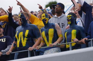 MORGANTOWN, WV - OCTOBER 26:  Fans of the West Virginia University Mountaineers cheer on their team during a Big East game against the University of Miami Hurricanes on October 26, 2002 at Mountaineer Field in Morgantown, West Virginia . Miami won 40-23.  (Photo By Doug Pensinger/Getty Images)