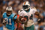 CHARLOTTE, NC - NOVEMBER 19:  Ricky Williams #34 of the Miami Dolphins runs away from Richard Marshall #31 of the Carolina Panthers during their game at Bank of America Stadium on November 19, 2009 in Charlotte, North Carolina.  (Photo by Streeter Lecka/Getty Images)