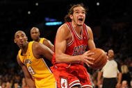 LOS ANGELES, CA - NOVEMBER 19:  Joakim Noah #13 of the Chicago Bulls goes to the basket past Kobe Bryant #24 of the Los Angeles Lakers during the game on November 19, 2009 at Staples Center in Los Angeles, California.  The Lakers won 108-93.  NOTE TO USER: User expressly acknowledges and agrees that, by downloading and/or using this Photograph, User is consenting to the terms and conditions of the Getty Images License Agreement.   (Photo by Harry How/Getty Images)