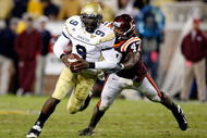 ATLANTA - OCTOBER 17:  Quarterback Josh Nesbitt #9 of the Georgia Tech Yellow Jackets rushes upfield away from Nekos Brown #47 of the Virginia Tech Hokies at Bobby Dodd Stadium on October 17, 2009 in Atlanta, Georgia.  (Photo by Kevin C. Cox/Getty Images)