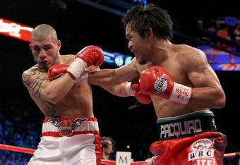 LAS VEGAS - NOVEMBER 14:  (R-L) Manny Pacquiao throws a right to the head of Miguel Cotto during their WBO welterweight title fight at the MGM Grand Garden Arena on November 14, 2009 in Las Vegas, Nevada.  (Photo by Al Bello/Getty Images)