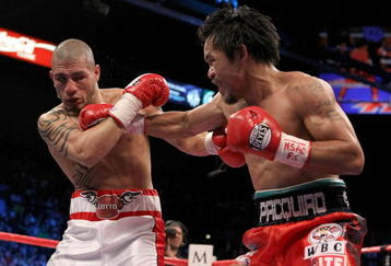 LAS VEGAS - NOVEMBER 14:  (R-L) Manny Pacquiao throws a right to the head of Miguel Cotto during their WBO welterweight title fight at the MGM Grand Garden Arena on November 14, 2009 in Las Vegas, Nevada.  (Photo by Al Bello/Getty Images)