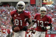 GLENDALE, AZ - DECEMBER 23:  Anquan Boldin #81 of the Arizona Cardinals celebrates his second touchdown of the game in front of Kurt Warner #13 for a 14-7 lead against the Atlanta Falcons during the second quarter at University of Phoenix Stadium on December 23, 2007 in Glendale, Arizona.  (Photo by Harry How/Getty Images)