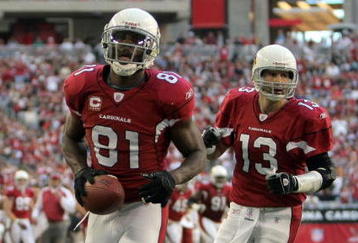 GLENDALE, AZ - DECEMBER 23:  Anquan Boldin #81 of the Arizona Cardinals celebrates his second touchdown of the game in front of Kurt Warner #13 for a 14-7 lead against the Atlanta Falcons during the second quarter at University of Phoenix Stadium on December 23, 2007 in Glendale, Arizona.  (Photo by Harry How/Getty Images)