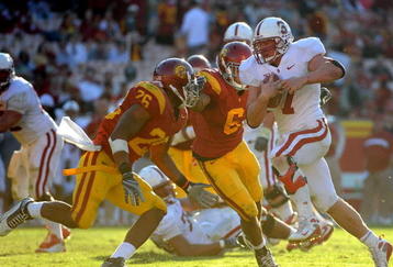 LOS ANGELES, CA - NOVEMBER 14:  Toby Gerhart #7 of the Stanford Cardinalis is chased by Will Harris #26 and Malcolm Smith #6 of the USC Trojans during the second half at the Los Angeles Memorial Coliseum on November 14, 2009 in Los Angeles, California.  Stanford won 55-21.  (Photo by Harry How/Getty Images)
