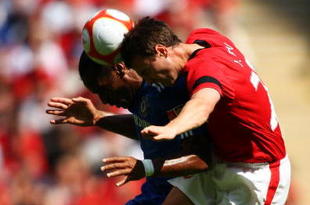 LONDON, ENGLAND - AUGUST 09:  Jonny Evans of Manchester United jumps with Didier Drogba of Chelsea  during the FA Community Shield match between Manchester United and Chelsea at Wembley Stadium on August 9, 2009 in London, England.  (Photo by Phil Cole/Getty Images)