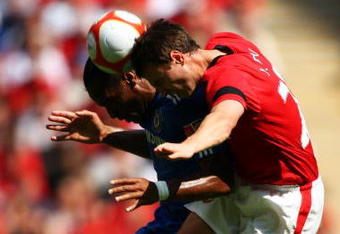 LONDON, ENGLAND - AUGUST 09:  Jonny Evans of Manchester United jumps with Didier Drogba of Chelsea  during the FA Community Shield match between Manchester United and Chelsea at Wembley Stadium on August 9, 2009 in London, England.  (Photo by Phil Cole/Getty Images)