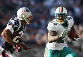 FOXBORO, MA - NOVEMBER 08:  Ronnie Brown #23 of the Miami Dolphins carries the ball as Leigh Bodden #23  of the New England Patriots defends on November 8, 2009 at Gillette Stadium in Foxboro, Massachusetts.  (Photo by Elsa/Getty Images)